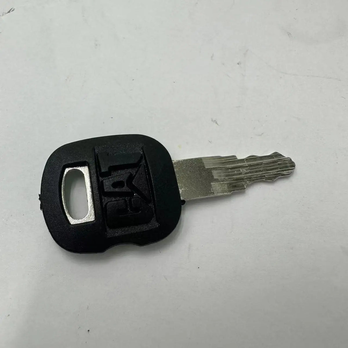 A black ignition key set with a blade is shown on a white background.