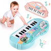 A child is playing a light blue electronic piano toy with a microphone, next to a pink version of the same instrument.