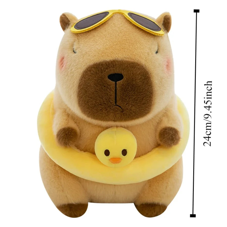 A brown capybara plush toy wearing a yellow duck swim ring and sunglasses.