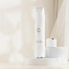 A white 2-in-1 electric shaver standing upright on a light surface.