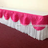 Elegant ice silk table skirt with matching top swag in pink and white for a wedding display.