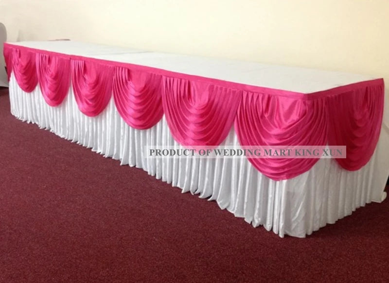 Elegant ice silk table skirt with matching top swag in pink and white for a wedding display.