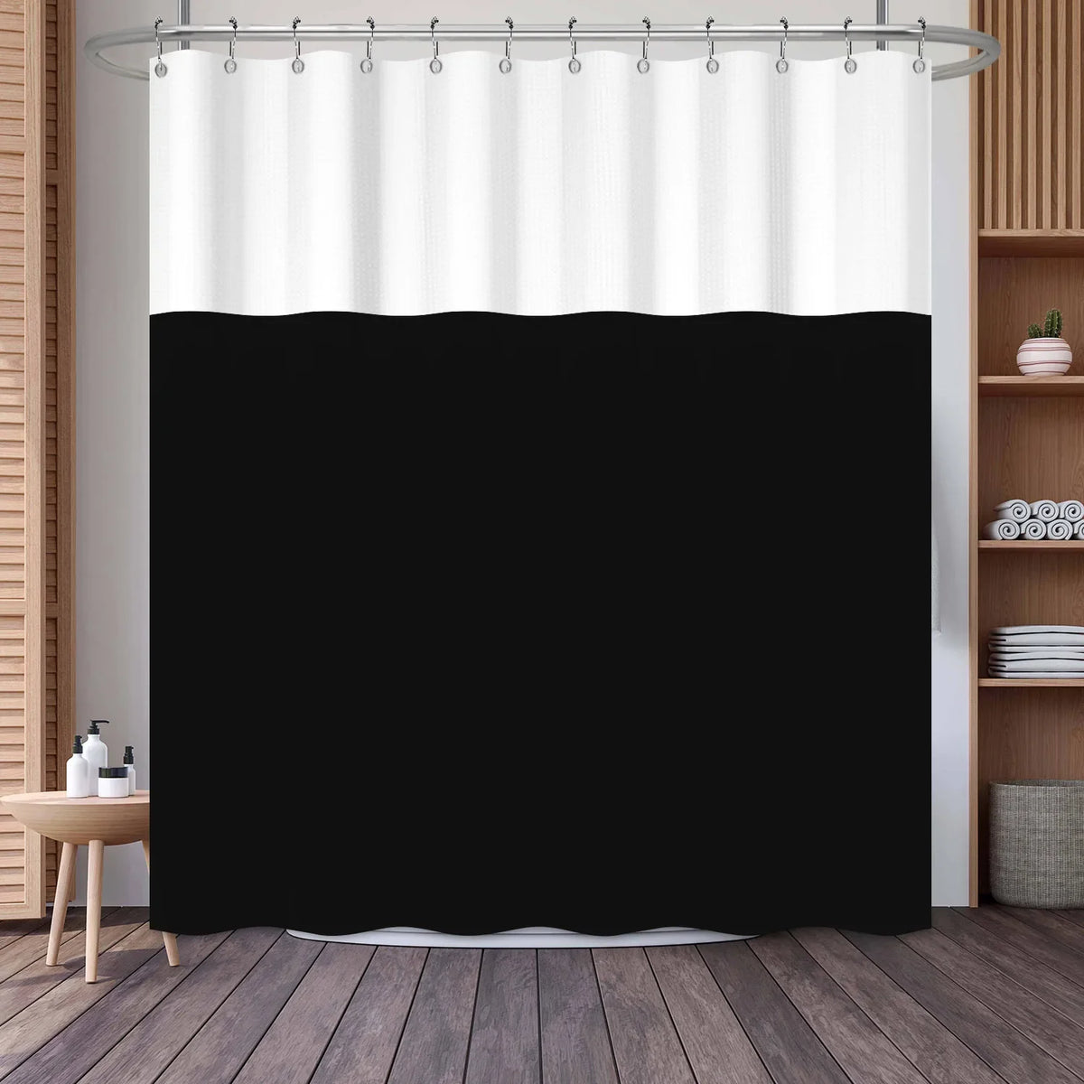 A white and black striped waffle weave shower curtain hanging from a metal rod.