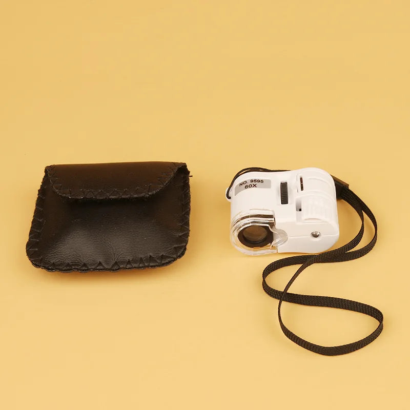 White 60X LED handheld magnifier with UV light and black storage pouch on a beige background.