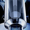Close-up view of a sleek, modern handheld car vacuum cleaner with a clear cylindrical body and pleated nozzle.