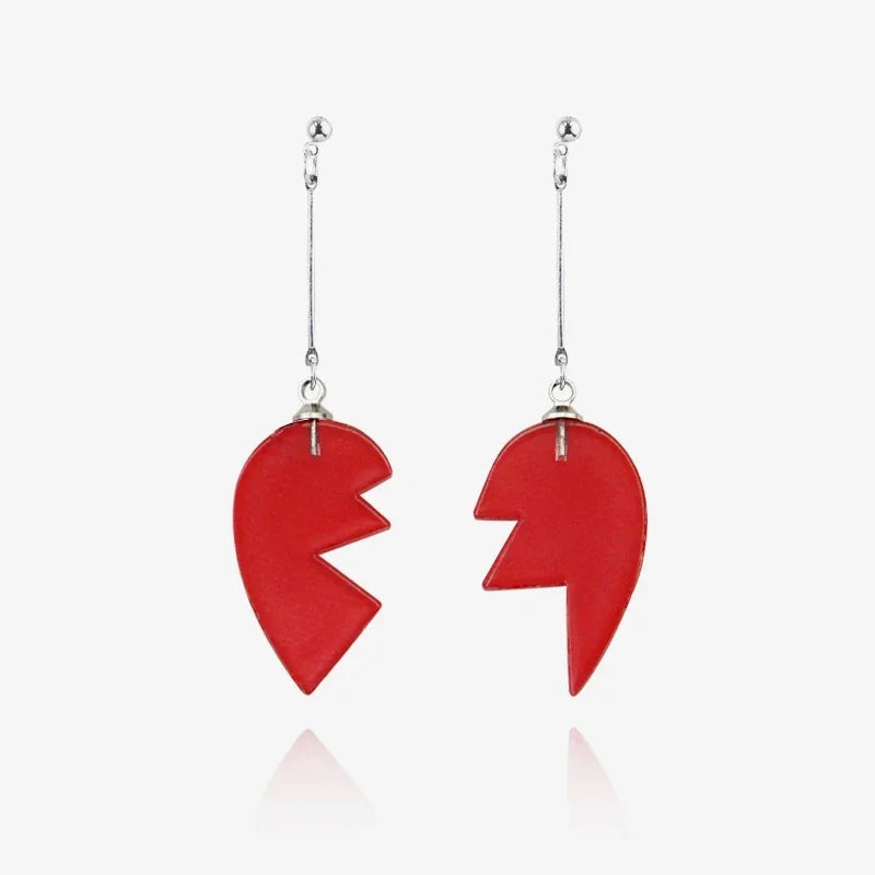 A red stone pendant necklace featuring a jagged, heart-like shape suspended from a silver chain.