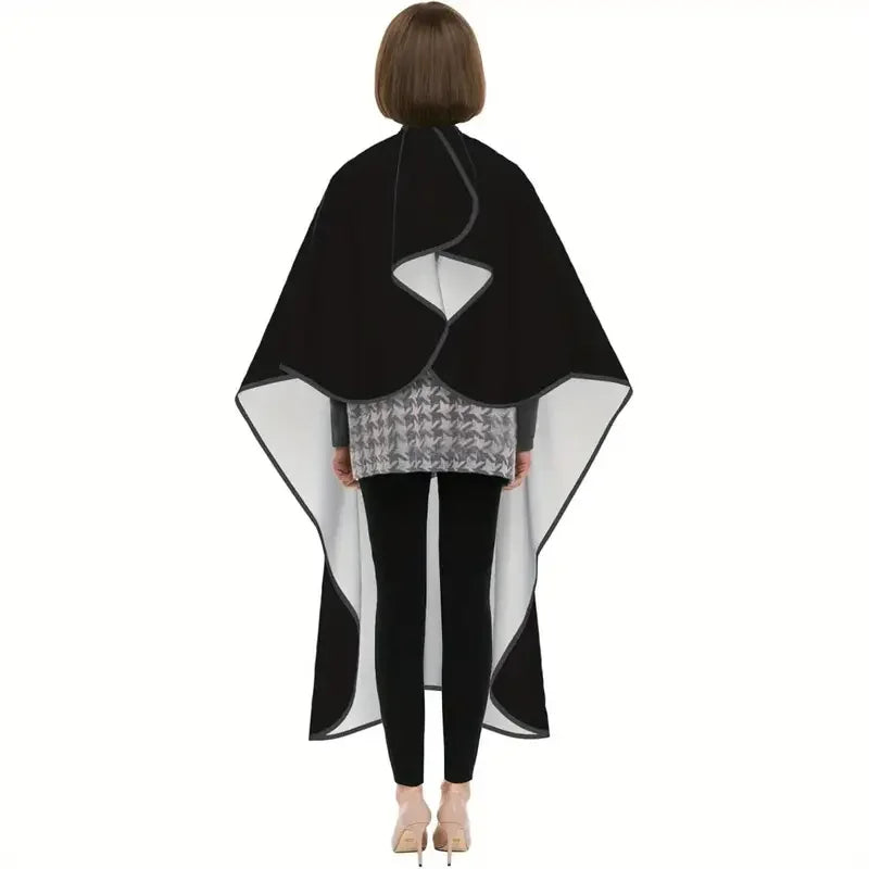 A black professional salon hair cutting cape with a gray patterned underlayer and adjustable hook.