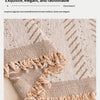 Close-up of a beige woven fabric featuring a delicate fishbone pattern and a fringed edge.