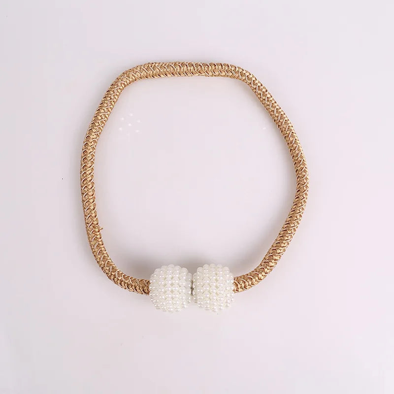 A set of eight elegant pearl magnetic curtain tie-back clips on a golden braided cord.