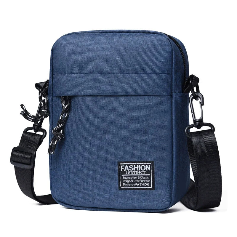 A navy blue mini crossbody phone bag with adjustable black strap and hardware.