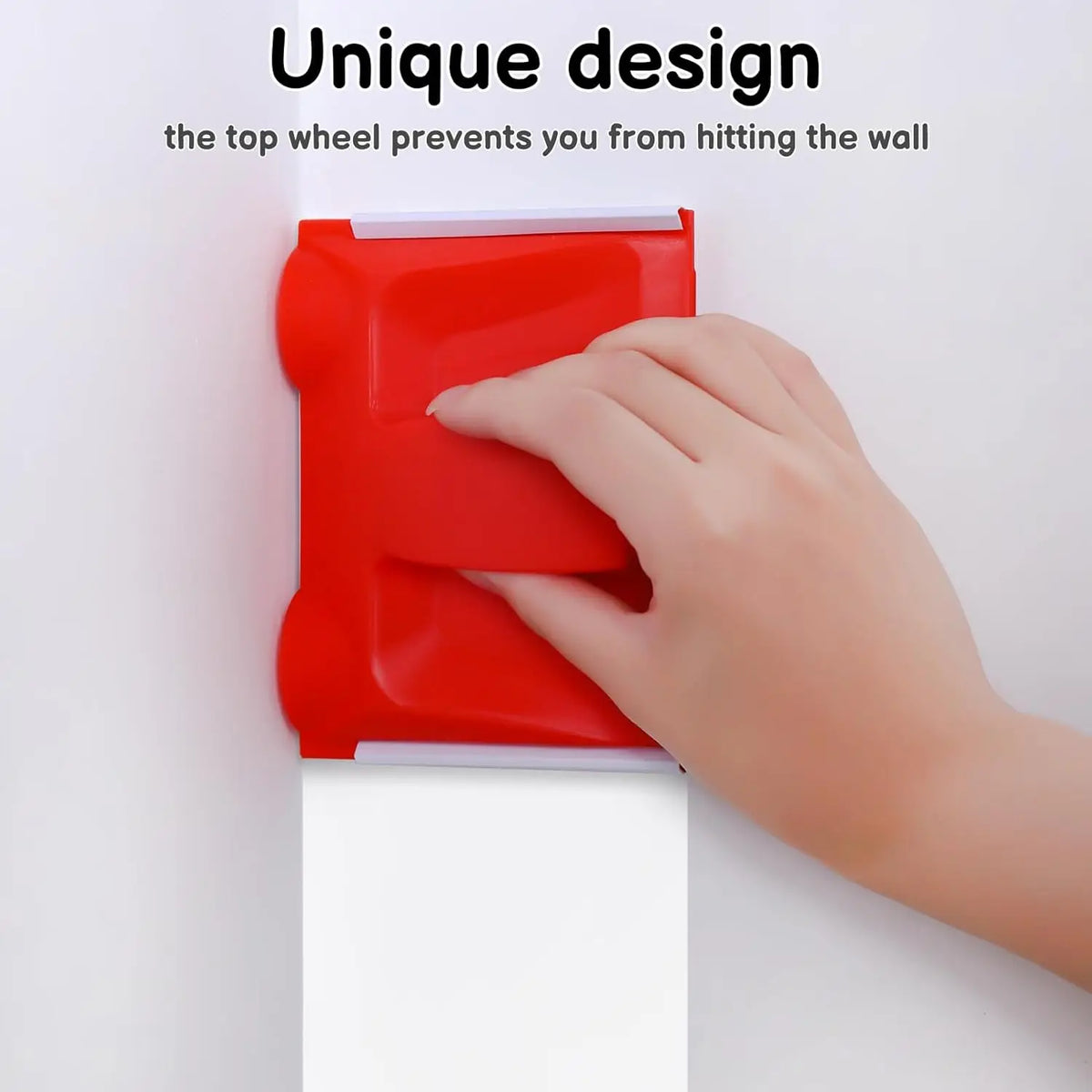 A hand is using a red paint edger tool to prevent hitting a wall while painting.