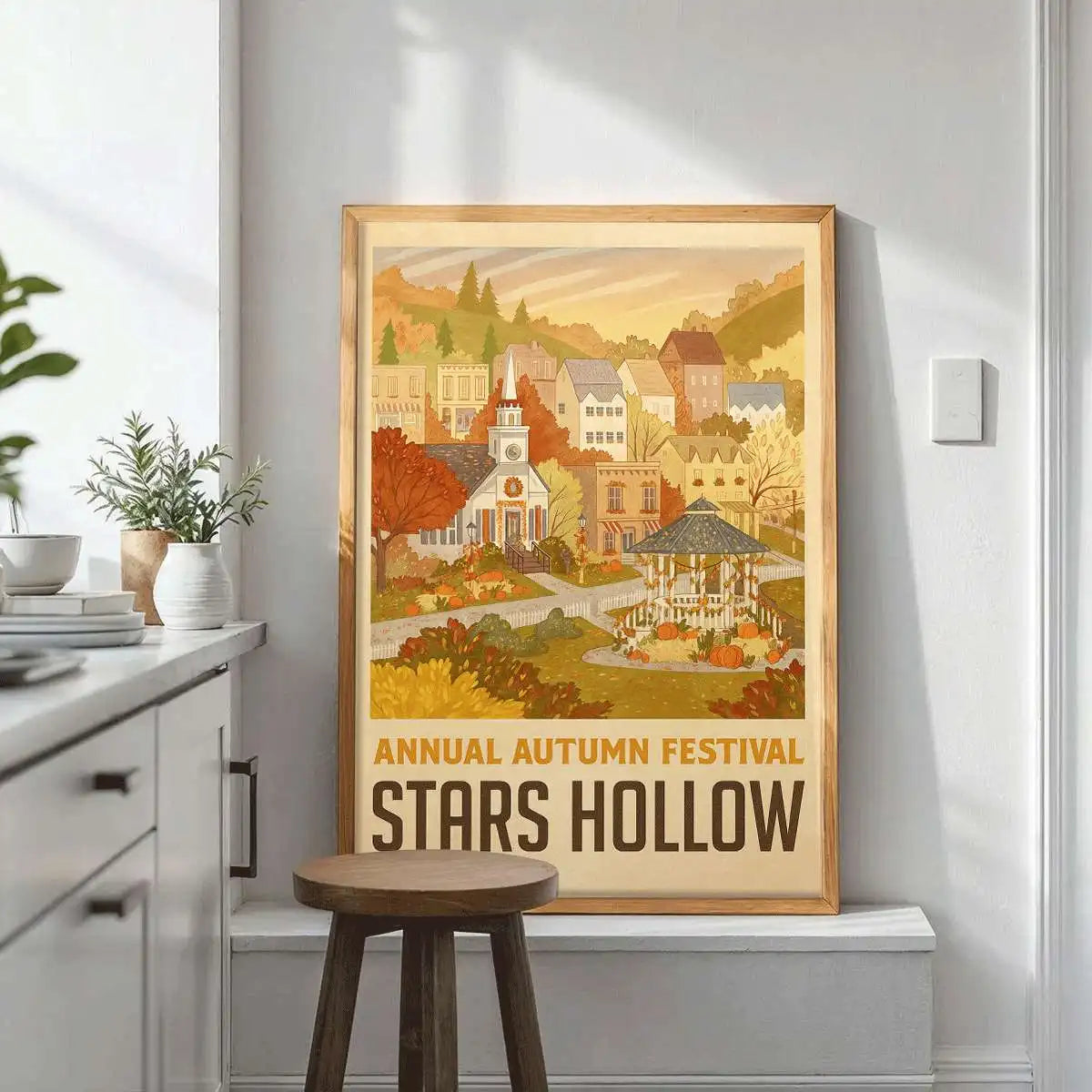A framed canvas print depicting a scenic autumn landscape with trees and buildings for wall decor.