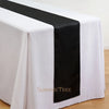 Elegant satin black table runner draped on a white tablecloth.