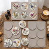 A tray of six silicone molds containing various floral and herbal aromatherapy discs for soap or hanging.