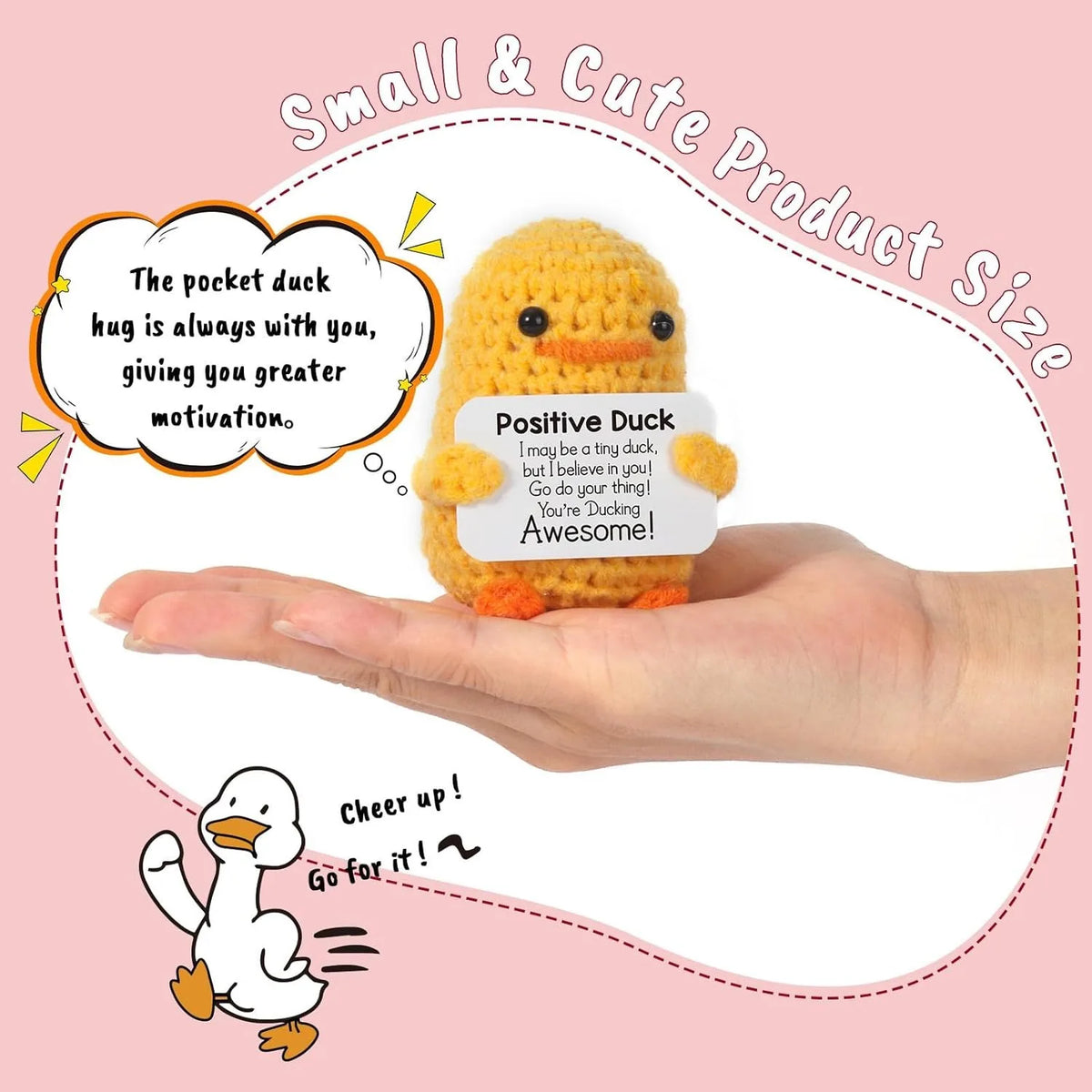 A yellow crochet duck figurine is held in a hand, with an inspirational card nearby.