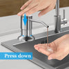 Hand pressing down on a stainless steel under-sink soap dispenser with an extension tube