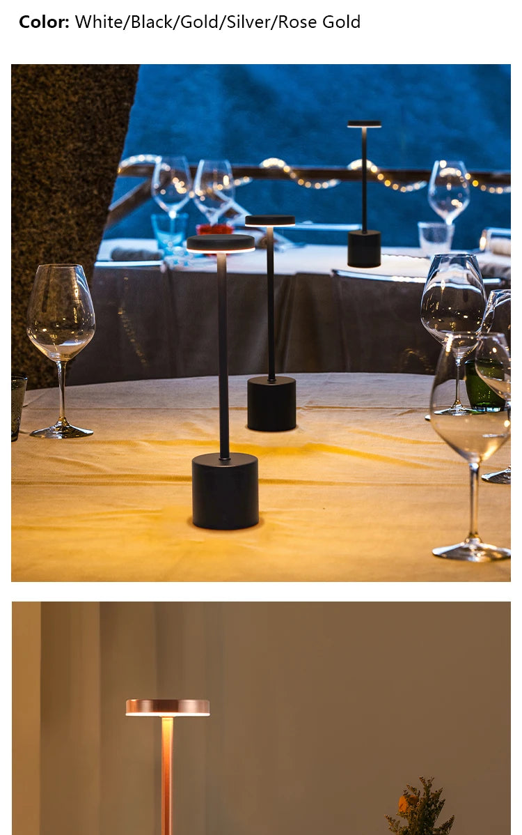 A close-up of a modern table lamp with a rose gold finish on a wooden surface.