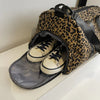A leopard print weekender tote bag with a compartment designed to hold shoes.
