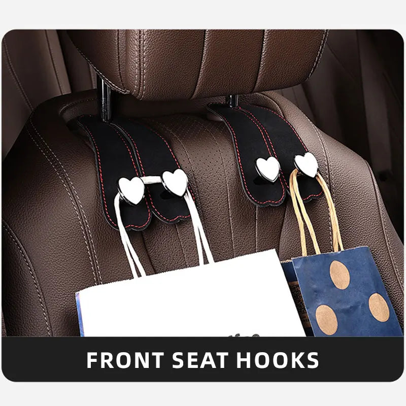Front seat hooks with dual hangers for securing bags and phones on a car seat headrest