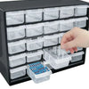 A black wall-mounted organizer with 25 clear plastic compartments and drawers, showing a hand interacting with the bottom sec