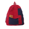 A red and navy canvas patchwork backpack with multiple pockets.