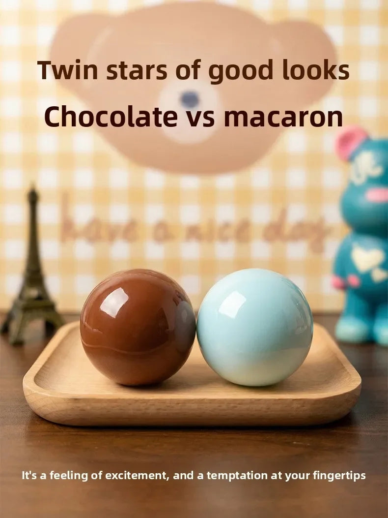 Two round stress balls, one chocolate brown and one light blue, are displayed on a wooden tray.