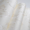Roll of white embossed damask wallpaper featuring delicate floral scrollwork design.