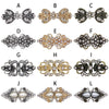A series of twelve vintage swirl sweater clips in silver, gold, and antique finishes.