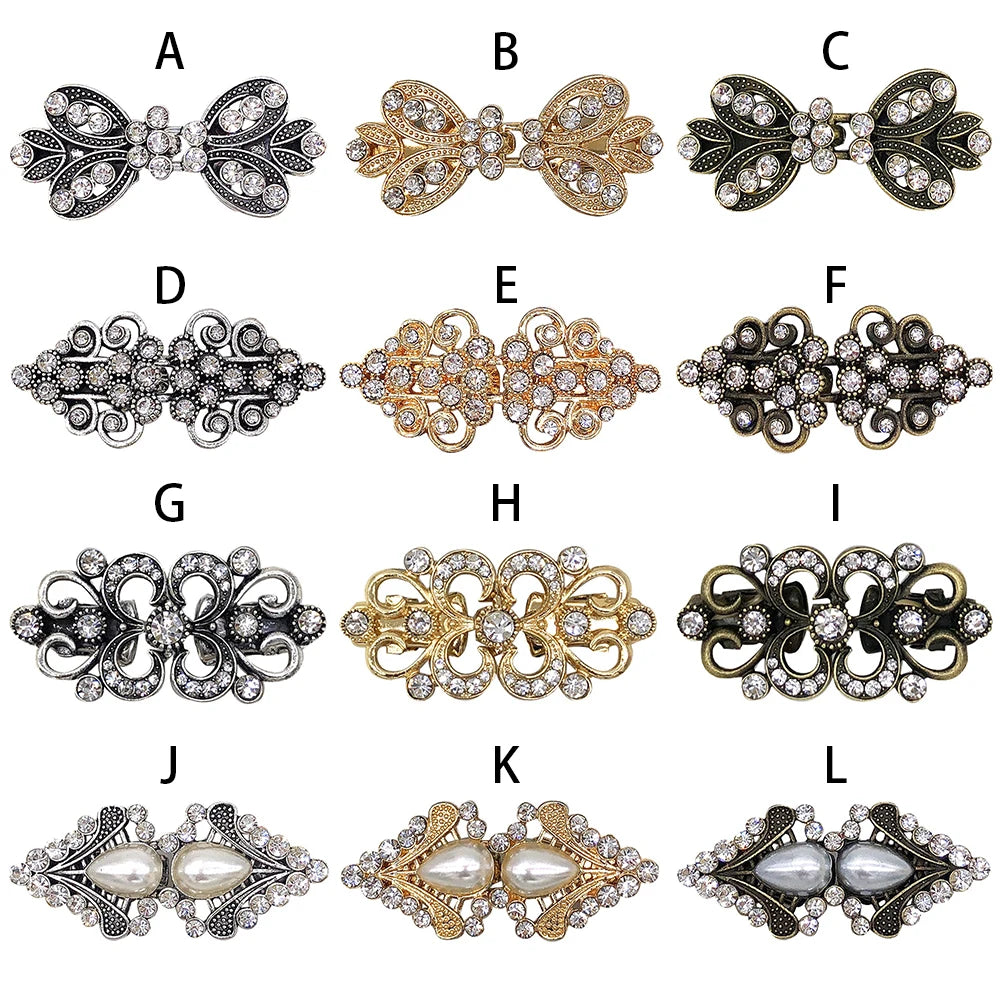 A series of twelve vintage swirl sweater clips in silver, gold, and antique finishes.