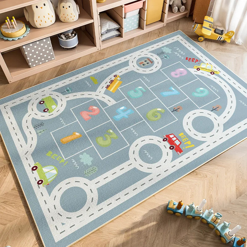 A blue and white cartoon car traffic play mat with numbered spaces for kids in a nursery setting.