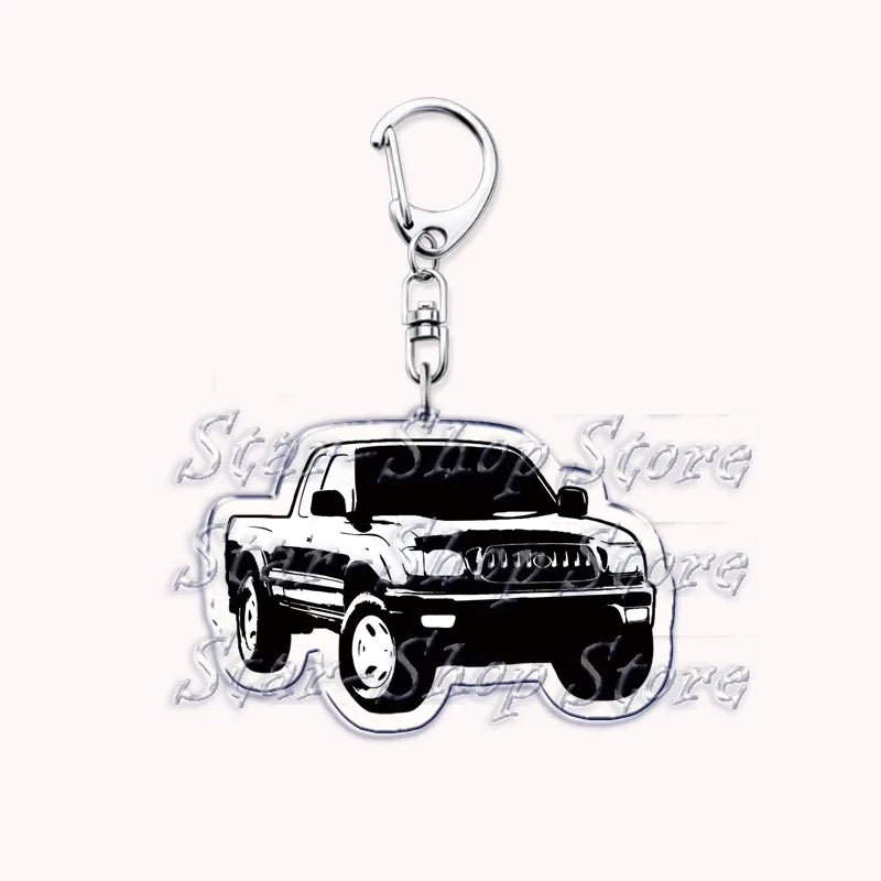 A silver metal key ring attached to a black off-road truck charm.