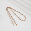 Gold-toned metal chain shoulder strap buckle for a crossbody bag