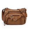 A brown classic leather tote bag with a padded design and adjustable strap.