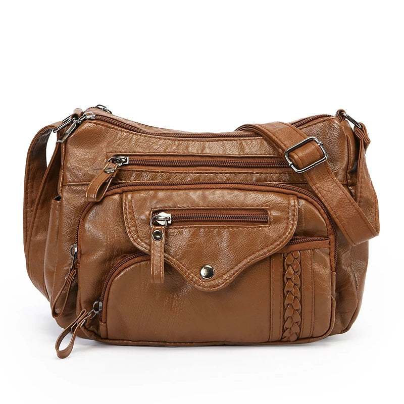 A brown classic leather tote bag with a padded design and adjustable strap.