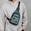 A gray hoodie features a dark teal water-resistant crossbody bag attached to the shoulder strap.