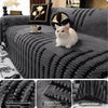 A gray woven sofa cover featuring black stripes and textured details, with a white cat sitting on it.