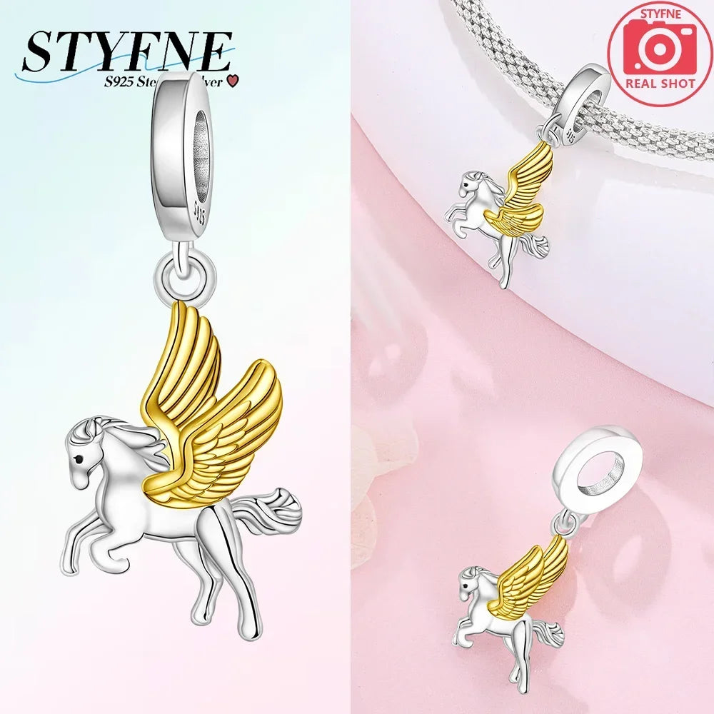 Silver pendant featuring a unicorn and pegasus charm with gold accents and sparkling crystals