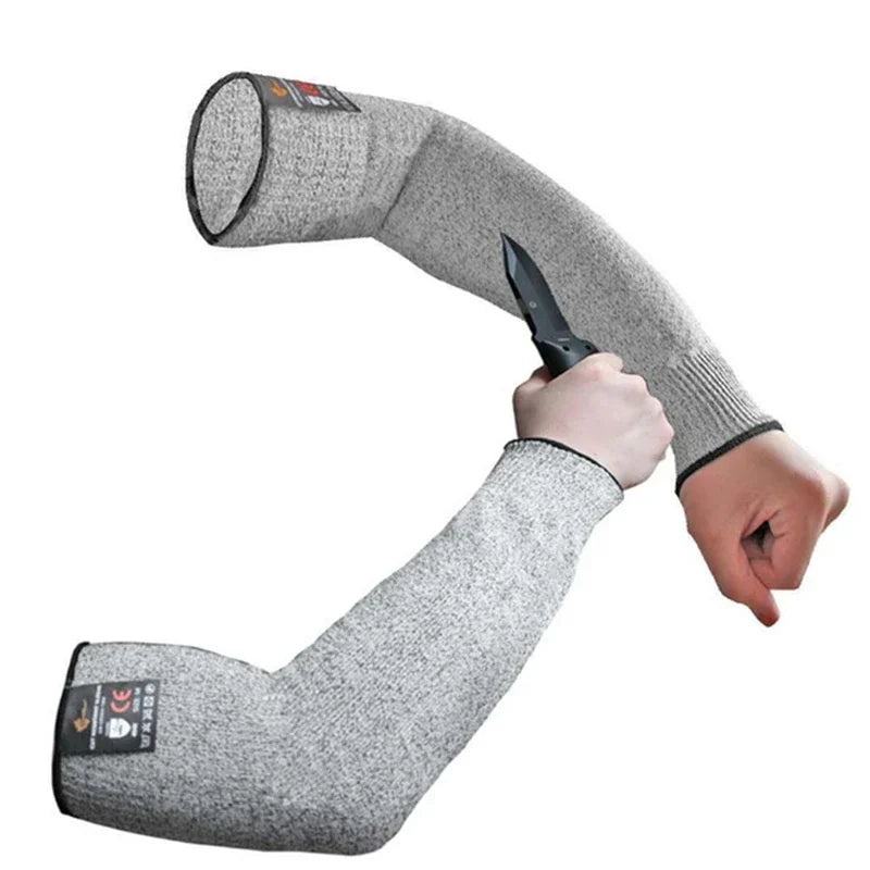 Gray cut-resistant arm sleeve being worn on an arm.