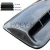 A close-up view of a black and gray carbon fiber textured hood scoop cover made of ABS material with a UV coating.