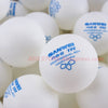 A close-up view of white Sanwei TR professional table tennis balls.