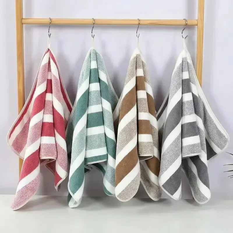 A set of striped microfiber towels hanging on a wooden rack.