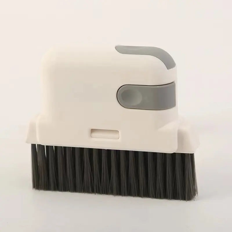 A white multi-purpose crevice cleaning brush with a gray head and dark bristles.