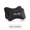 A pair of black PU leather car headrest pillows and seatbelt shoulder pads
