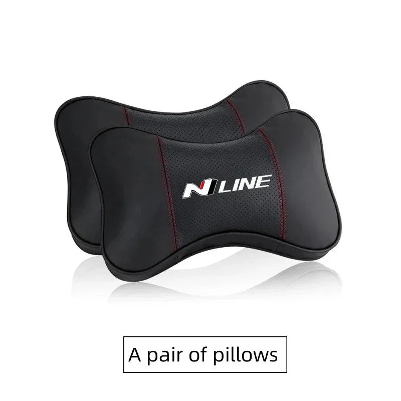 A pair of black PU leather car headrest pillows and seatbelt shoulder pads