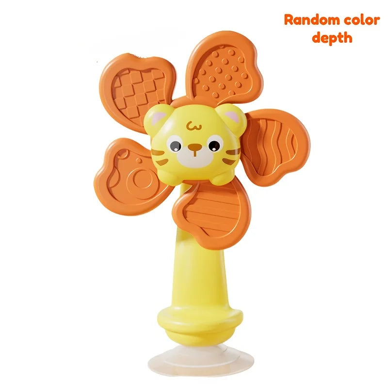 A yellow spinning toy shaped like a lion with orange, textured ears and a yellow base.