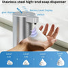 A hand holds a stainless steel automatic foam soap dispenser with various level settings displayed on the base.