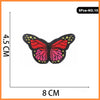 Five embroidered iron-on patches featuring a vibrant red and pink butterfly design.