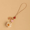 A gold-colored keychain pendant featuring a charm of a white dog paw print and pink beads on a thin cord.