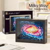 A framed Milky Way art piece displayed next to a box for the Starlit Sky product.