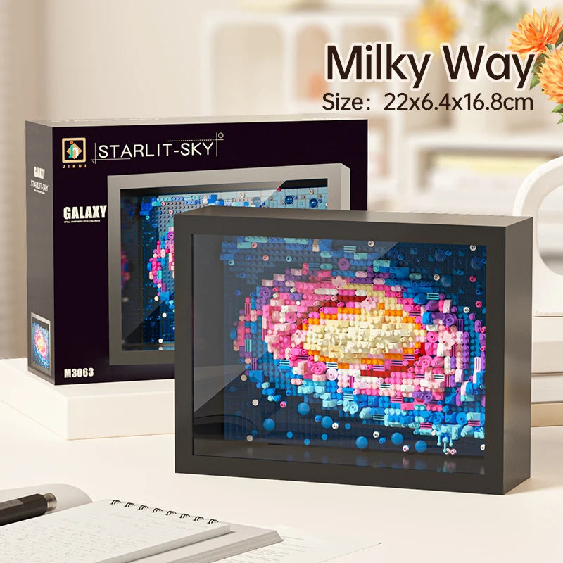 A framed Milky Way art piece displayed next to a box for the Starlit Sky product.